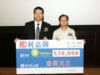 藍善會會長趙保杰先生將3萬元善款的支票移交予樂施會香港總監何渭枝先生代表接受